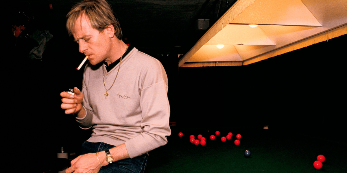 Alex Hurricane Higgins smoking at a snooker table