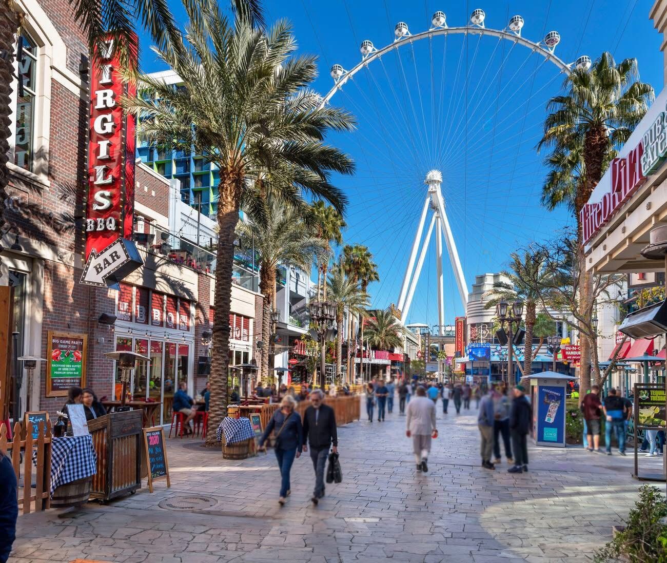The Las Vegas location of Virgil's Real BBQ viewed from the outside of LINQ Promenade in the daytime, with the High Roller in the background.